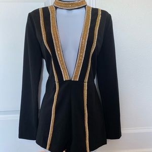 Romper , Black with Gold and silver. From boutique